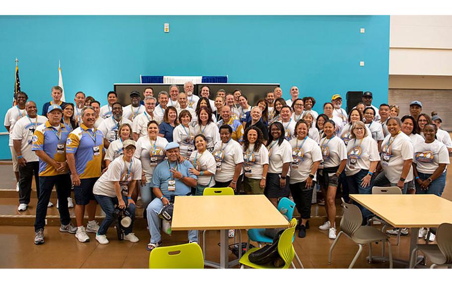 Yokota High School (YHS) alumni stand together for a group photo, Sept. 27, 2023, during a homecoming pep rally at Yokota Air Base, Japan. Throughout 2023, YHS has celebrated 50 years of educating military-affiliated children and serving the community of Yokota. (U.S. Air Force photo by Senior Airman Hannah Bean)