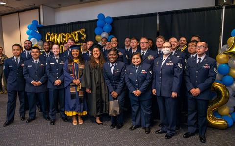 Photo Of Graduates of the 2025 Spring Community College of the Air Force pose for a photo at Yokota Air Base, Japan.