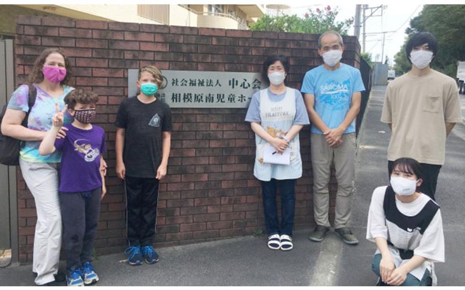 Camp Zama community member Jamie Clauss and her two sons — Sebastian, 12; and Seamus, 9 — pose for a photo with staff from the Sagami South Children’s Home in Sagamihara City, Japan, Aug. 28. The Clauss family was there as part of a volunteer visit in which they aimed to connect with the children there through playing popular American games and singing English-language singalong songs. (Photo Credit: Chihiro Suzuki, U.S. Army Garrison Japan Public Affairs)