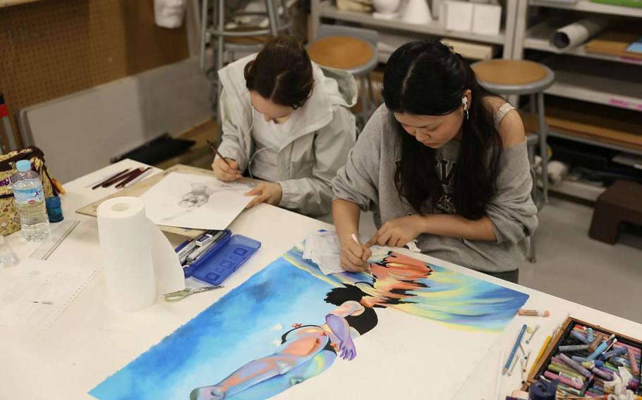 two girls drawing a picture