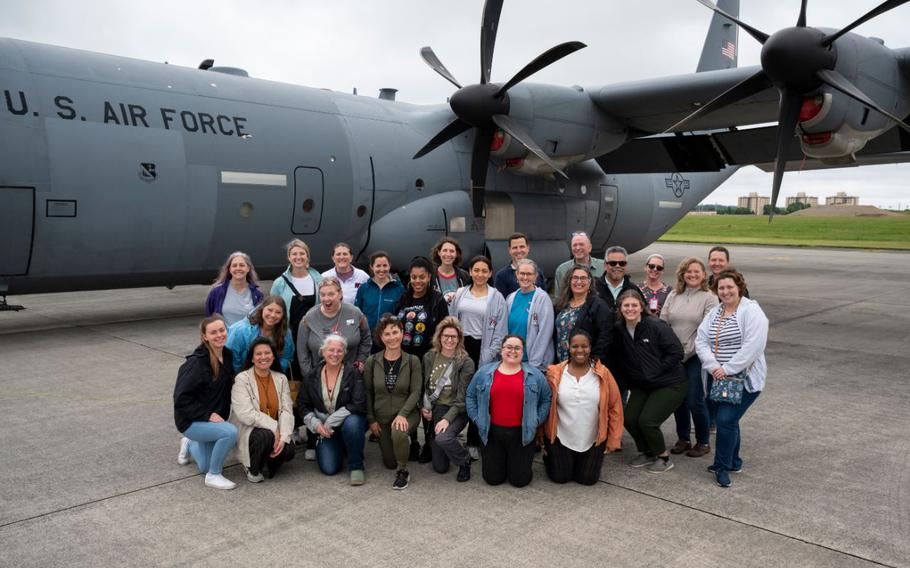 Department of Defense Education Activity teachers pose for a group photo in front of a C-130J Super Hercules assigned to the 36th Airlift Squadron before receiving a teacher appreciation flight at Yokota Air Base, Japan, May 7, 2024. The 374th Airlift Wing conducted the flights to show gratitude to Yokota teachers during Teacher Appreciation Week.