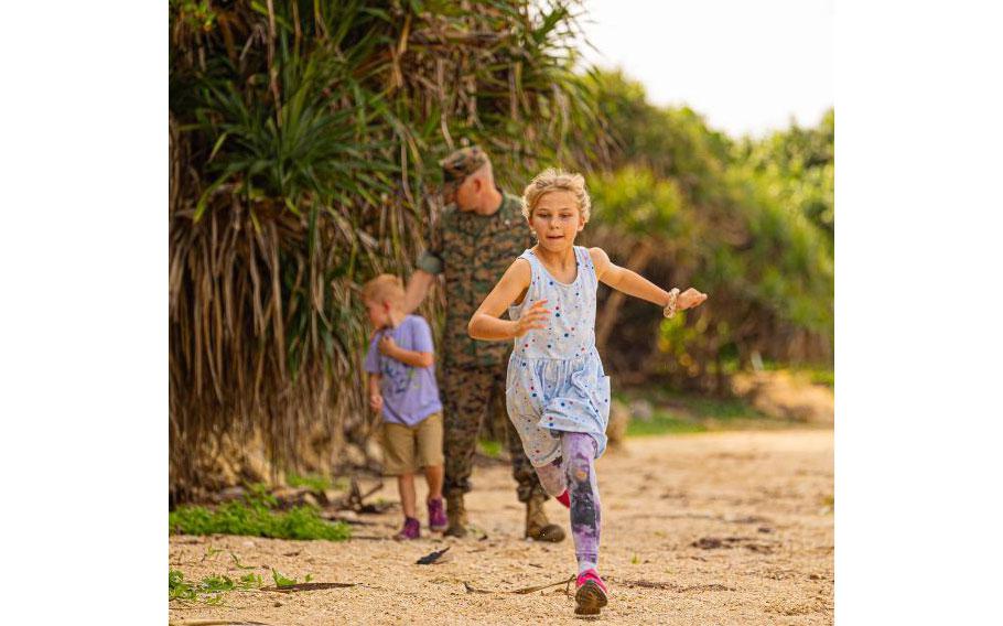Fiona Blyleven runs ahead of her brother, Sam, and her father, Lt. Col. Scott Blyleven, an operational planner with the 3rd Marine Expeditionary Brigade, on Camp Courtney Beach, Okinawa, Japan, April 15, 2024. The Month of the Military Child, celebrated annually in April, recognizes military children for the daily sacrifices and challenges they overcome.