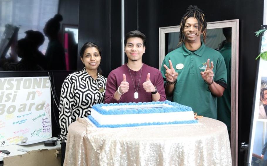 Asiel Morales, center, poses for a photo with Camp Zama Youth Center staff at his 2024 Military Month of the Year achievement celebration there April 5.