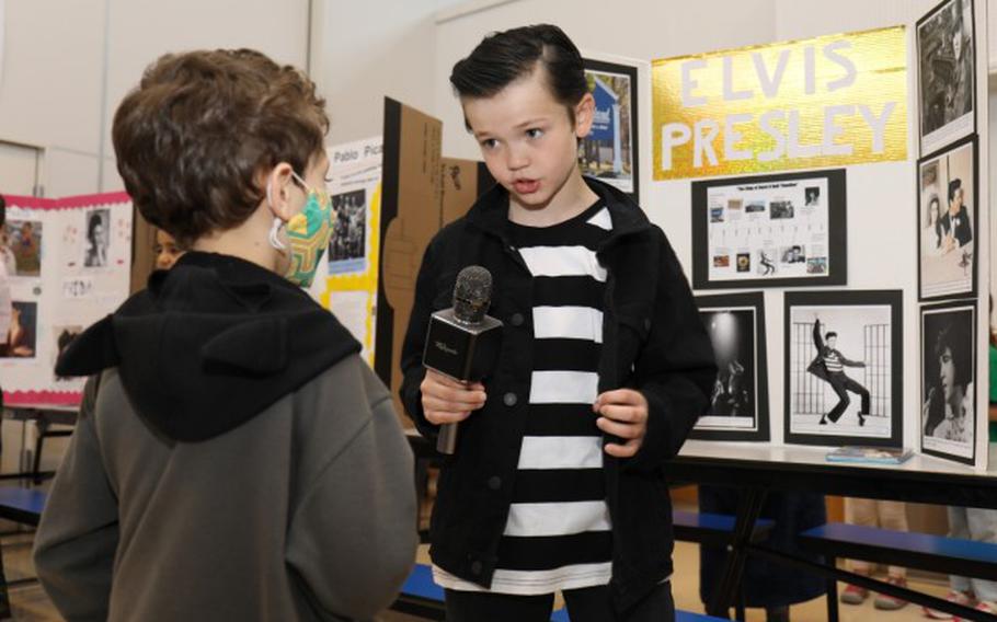 Mason Thomas, a fourth grader at Arnn Elementary School, portrays Elvis Presley during a living wax museum event in the school's cafeteria at Sagamihara Family Housing Area, Japan, March 17, 2023. More than 60 fourth graders participated in the event, which highlighted change makers from athletes, artists and authors to inventors, politicians, royalty and other trailblazers. (Photo Credit: Sean Kimmons)