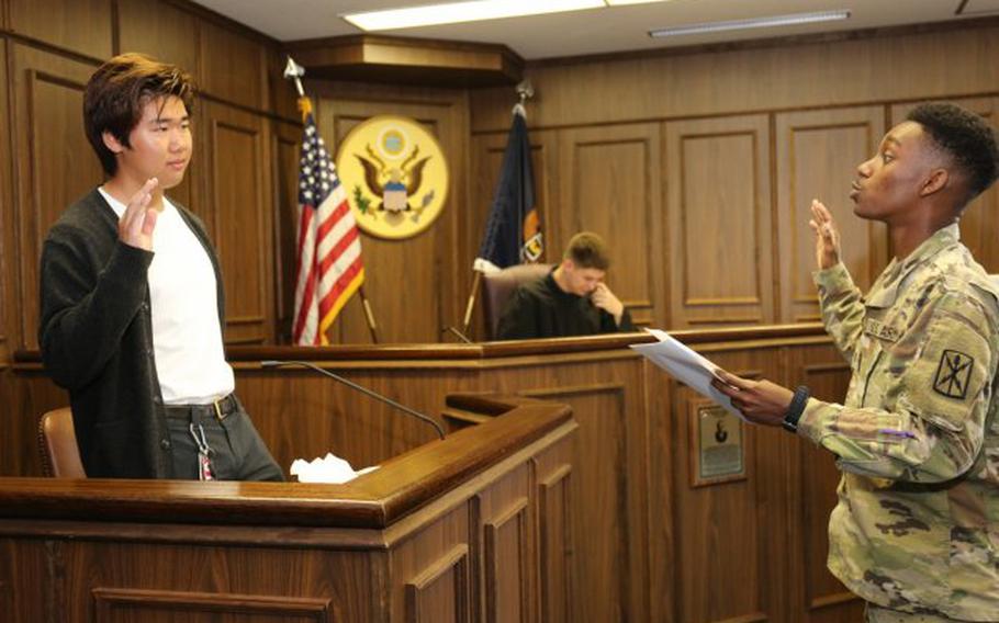 William Takahashi, a senior at Zama American Middle High School, takes the stand as a witness in a mock trial held April 26 in the U.S. Army Japan courtroom. Takahashi and 15 other ZAMHS seniors participated in the event as part of a "Law Day" celebration. (Photo Credit: Noriko Kudo, U.S. Army Garrison Japan Public Affairs)