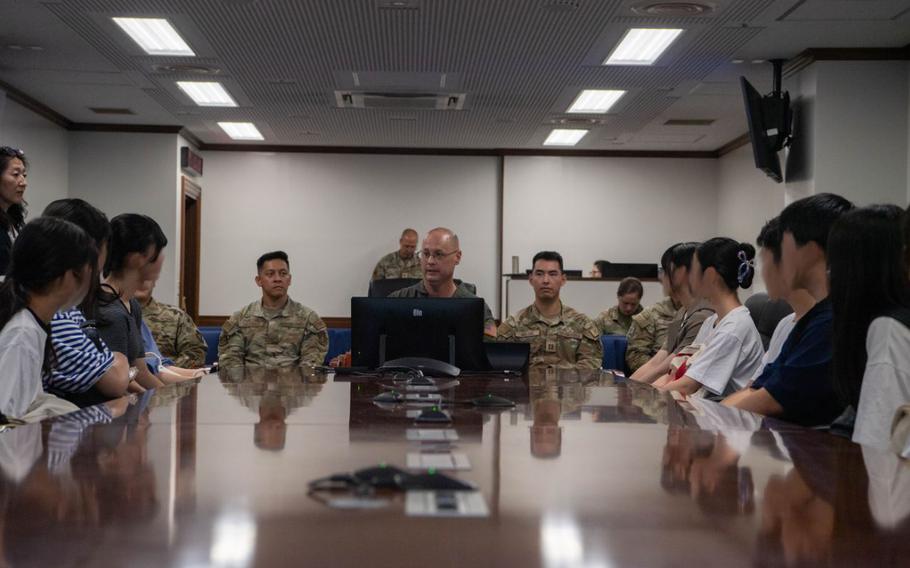 U.S. Air Force Col. Richard McElhaney, 374th Airlift Wing commander, welcomes high school students from the Musashimurayama City area at Yokota Air Base, Japan, Aug. 23, 2024. The high school tour was the first of its kind hosted by the base since COVID-19 began. Imagery has been altered for privacy reasons.