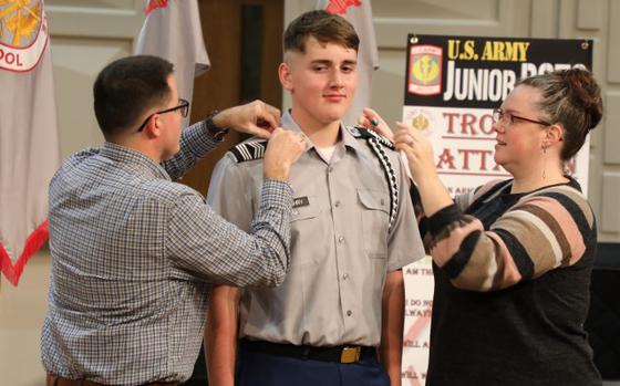 Photo Of Cadet Malachi Zachry, center, is promoted to master sergeant during a Junior Reserve Officers’ Training Corps recognition ceremony at Camp Zama, Japan, Oct. 17, 2024.