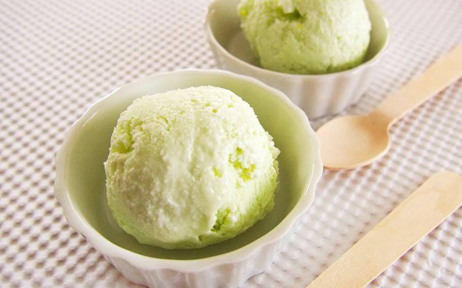 wasabi gelato in two small dishes and two spoons on the table.