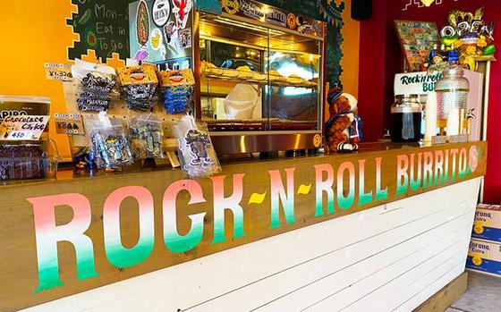 Colorful burrito-centric magnets and keychains adorn the register area in Rock-N-Roll Burrito, a family-owned Mexican cantina-style establishment located near Naval Air Facility Atsugi. Featured near the register is a glass case filled with freshly made empanadas, and surrounding it is other Latin American specialties like Tres Leche cake, and horchata, a sweetened plant-based milk. (Photo by Patrick Ciccarone)