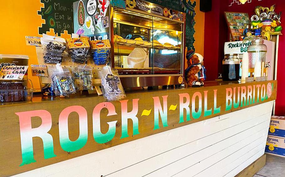 Colorful burrito-centric magnets and keychains adorn the register area in Rock-N-Roll Burrito, a family-owned Mexican cantina-style establishment located near Naval Air Facility Atsugi. Featured near the register is a glass case filled with freshly made empanadas, and surrounding it is other Latin American specialties like Tres Leche cake, and horchata, a sweetened plant-based milk. (Photo by Patrick Ciccarone)