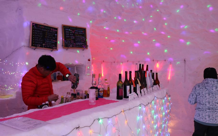 bartender and sake bottles at bar