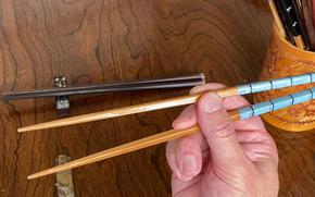 Takahiro shows how to hold chopsticks.