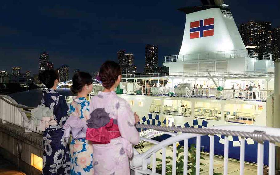3 women looking at the ship.