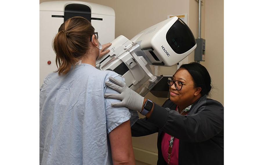 Amanda Lapointe, a mammography technologist at Naval Hospital Jacksonville, assists a patient during a mammogram on Sept. 15, 2023. Lapointe, a native of Jacksonville, Florida, says, “Early detection saves lives.” (U.S. Navy photo by Deidre Smith, Naval Hospital Jacksonville)