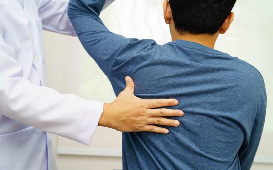 Physical therapy, Asian therapist doctor treat perform pain therapy in hospital.