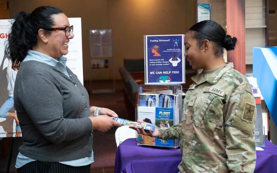 Dr. Diaz discusses the importance of mental fitness with Army Pvt. 2 Kaliyah Rowan at the Mental Fitness Information table during Staff Resiliency Week at Walter Reed. Diaz says prioritizing mental health is key to building resilience, and shared five ways staff members can do just that in honor of Mental Health Awareness Month: Being aware, taking advantage of resources, asking for help, practicing self-care and building a support system. Photo by Petty Officer 1st Class Jesse Sharpe