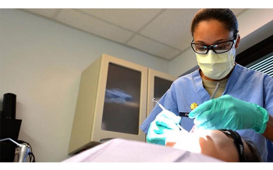 U.S. Air Force Major Rachael Parrish, 20th Dental Squadron general dentist, performs an oral exam on Airman 1st Class Amie Bickford, 20th Equipment Maintenance Squadron munitions technician at Shaw Air Force Base, South Carolina, March 13, 2017. Airmen assigned to the 20th DS are tasked with ensuring airmen and soldiers on base meet all dental class requirements for deployment (Airman 1st Class Christopher Maldonado, 20th Fighter Wing Public Affairs).