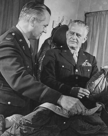 Col. Herbert B. Wright (left), the Chief of Professional Services, U.S. Army 8th Air Force and Brig. Gen. Malcolm C. Grow, at the time, Surgeon of the U.S. Army 8th Air Force, examine a heating bag Grow helped develop to keep fliers warm during high-altitude missions.