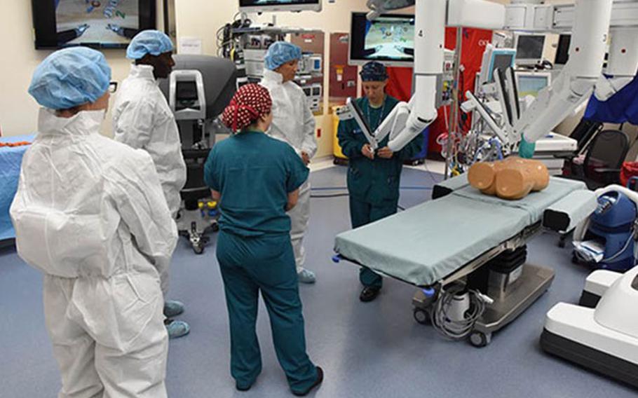 Second Lt. Nina Hoskins, 81st Surgical Operations Squadron operating room nurse, briefs Col. Debra Lovette, 81st Training Wing commander, and other base leadership on robotics surgery capabilities inside the robotics surgery clinic at the Keesler Medical Center June 16, 2017. (Photo: Kemberly Groue, U.S. Air Force)