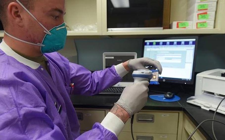 Air Force Staff Sgt. Cody Emery, 30th Medical Group medical lab technician, prepares a COVID-19 test sample for processing April 8, 2021, at Vandenberg Air Force Base, California (Photo by: Michael Peterson, Space Launch Delta 30 ).