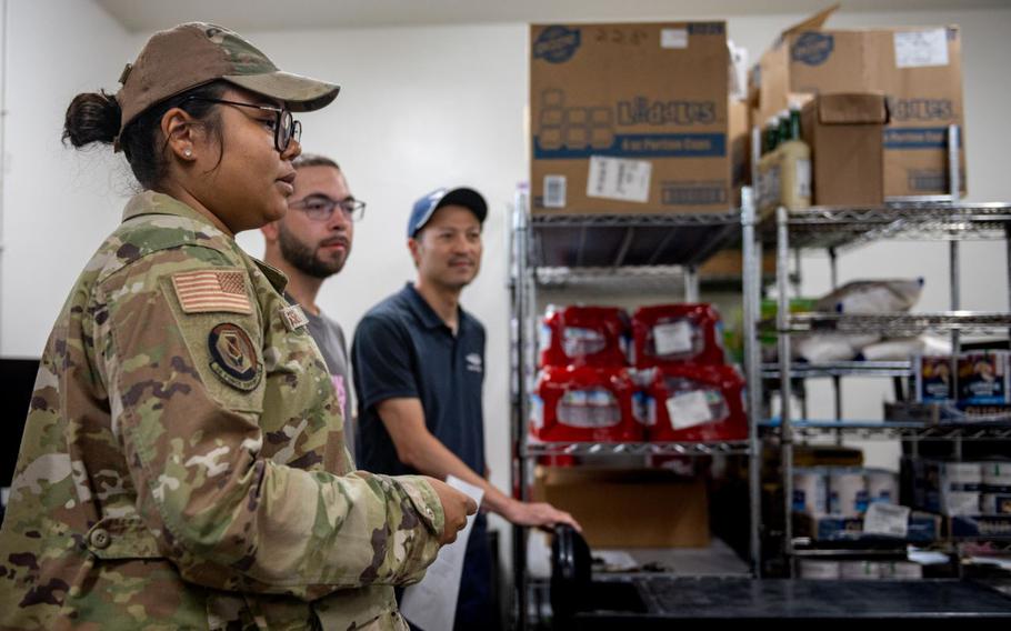 U.S. Air Force Staff Sgt. Jasmine Russell briefs dining facility personnel.