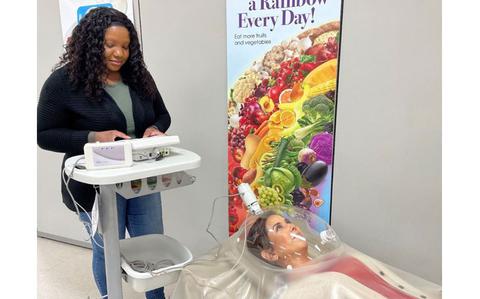 Photo Of Armed Forces Wellness Center employees demonstrate a metabolic assessment at Camp Zama, Japan. Participants in the “Biggest Loser” competition will be able to use the test to identify their unique target caloric zone as they seek to achieve and maintain a healthy weight and body composition. 