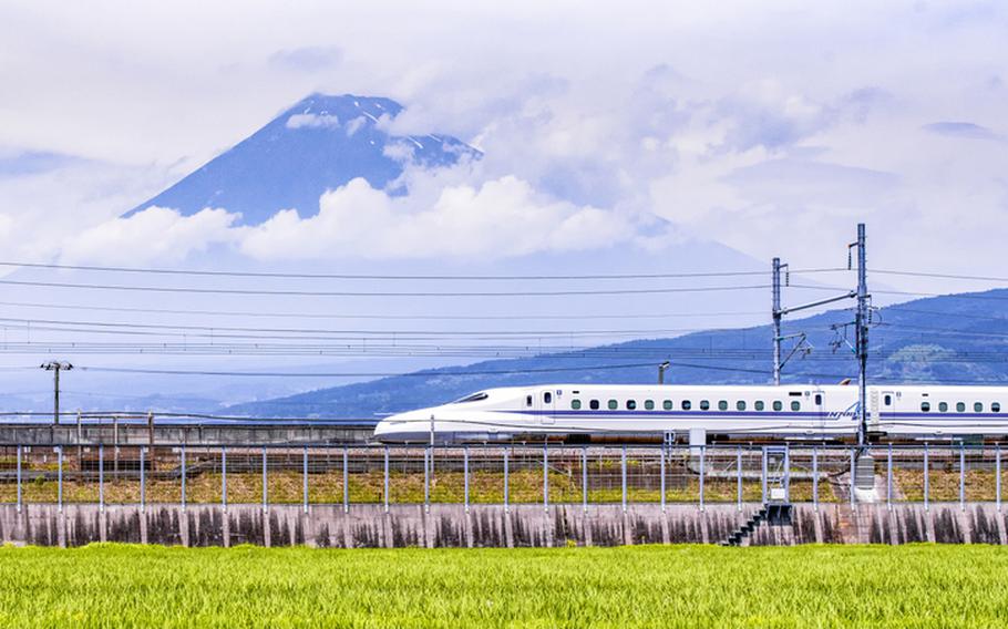 Japan – July 2019 : High Speed Train passing Fuji Mountain Background in Summer, Fuji City, Shizuoka, Japan
