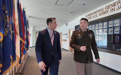 Photo Of Sgt. Nikolas Castronovo walking in the hallway with another person.