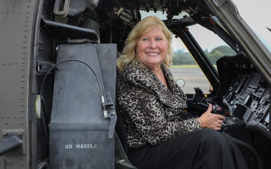 Trudy Floyd, who was born on Camp Zama in 1959, sits inside the cockpit of a UH-60 Black Hawk helicopter at the installation’s Kastner Airfield in Japan.