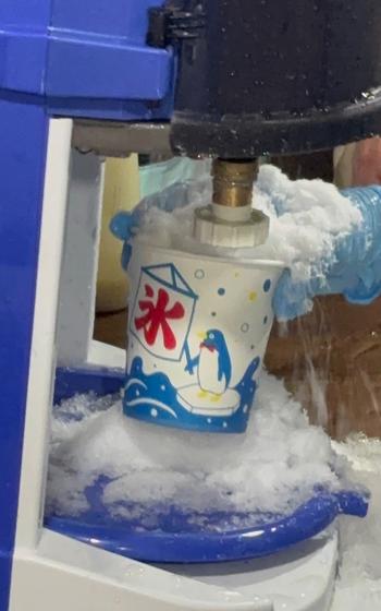 A man is making shaved ice.