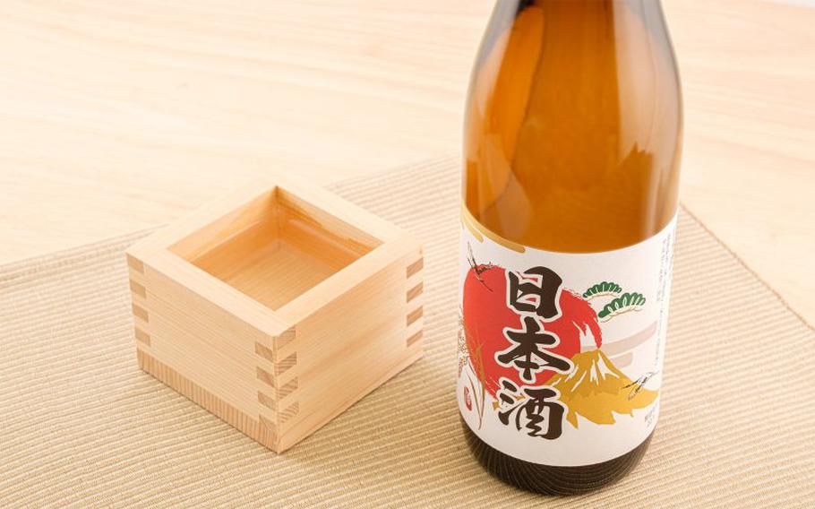 A bottle of sake and masu or a square wooden cup.