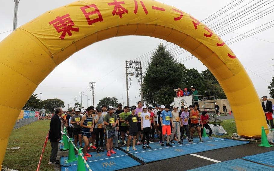 In a crowdy weather, runners in the 8th East Japan Half Marathon prepare to take off from the starting line .