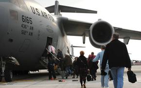 Passengers get on a plane.