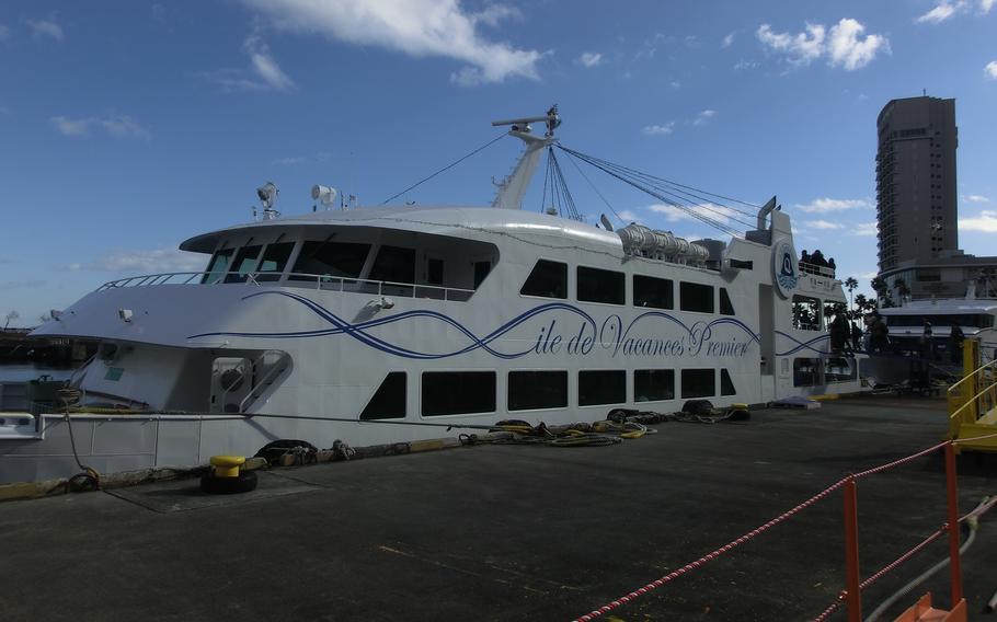 Passengers embark on a high-speed boat at Atami port.