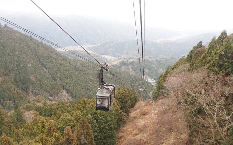 A ropeway to climb the mountain can be seen.