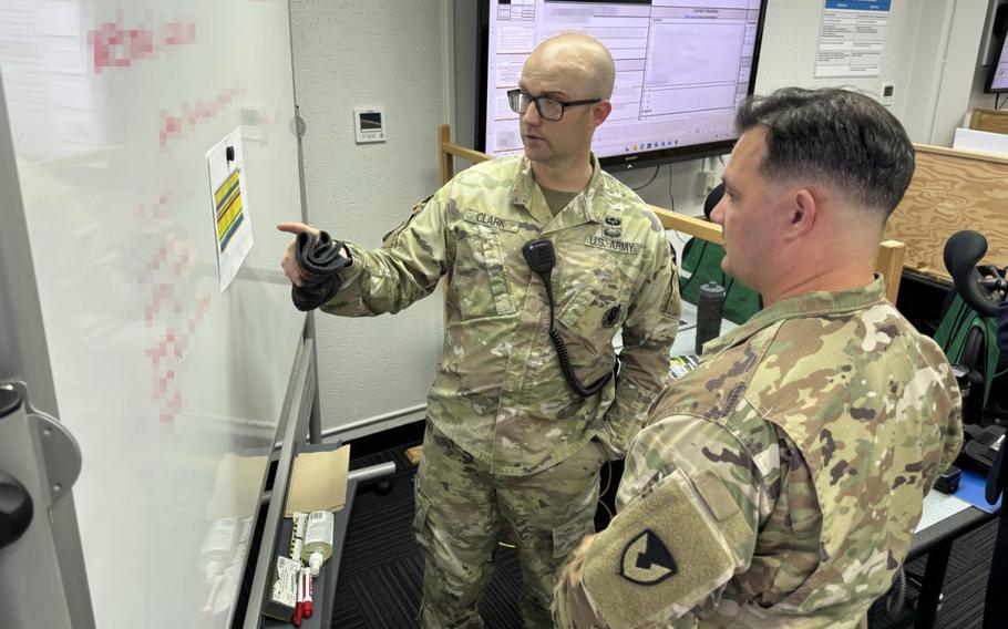 From left, Maj. Michael Clark and Sgt. 1st Class Jimmie Gilchrist, both assigned to U.S. Army Garrison Japan’s Directorate of Plans, Training, Mobilization and Security, work in the garrison’s Emergency Operations Center July 2, 2024, during “Black Start,” an exercise meant to test the energy resilience of Camp Zama by having the installation’s backup systems kick in during a power outage drill. 