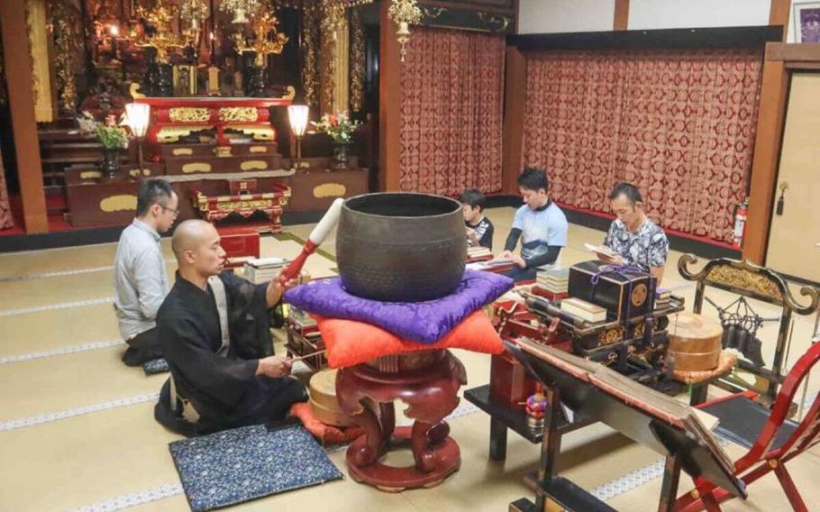 four participants and a priest during Shodaigyo chanting.