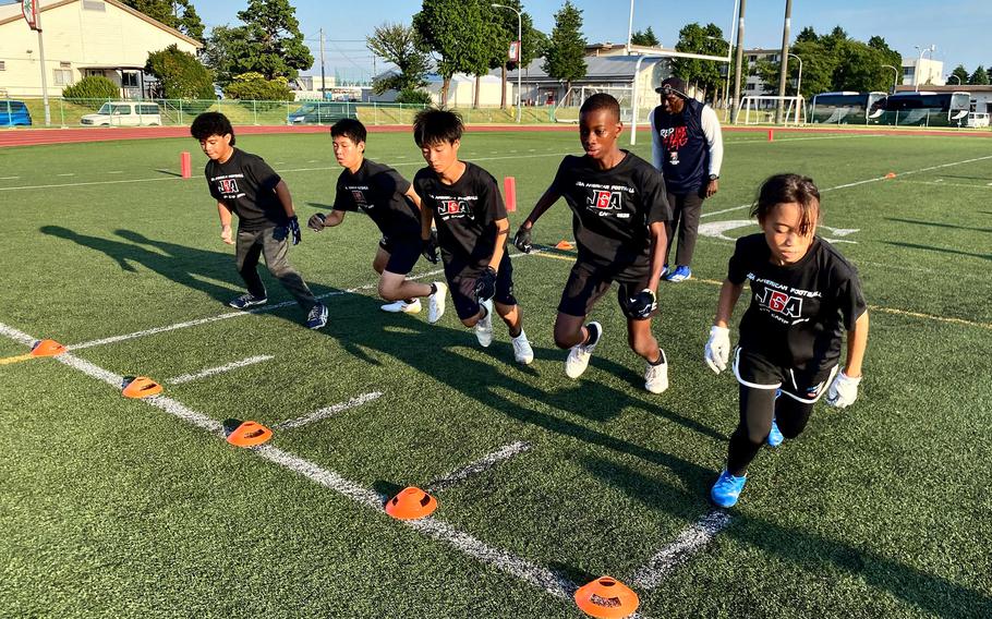 Student athletes participate in football drills during a Japan Gridiron Association (JGA) American football camp held onboard the installation