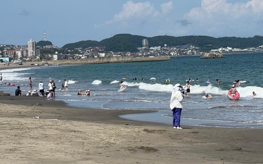 People enjoy themselves on Miura Beach.