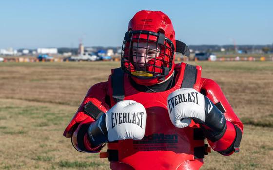 Photo Of U.S. Air Force Airman Justin Shult prepares for a demonstration in a redman suit..