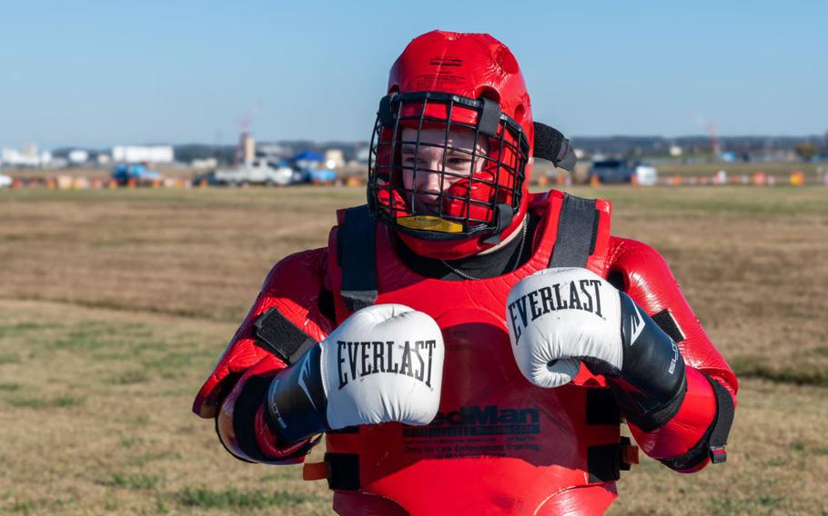 U.S. Air Force Airman Justin Shult prepares for a demonstration in a redman suit..