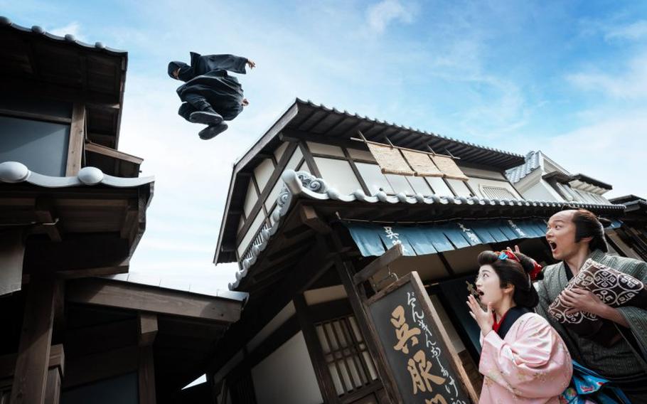 a ninja jumping on the roof, and two people on the street are surprised to see it.