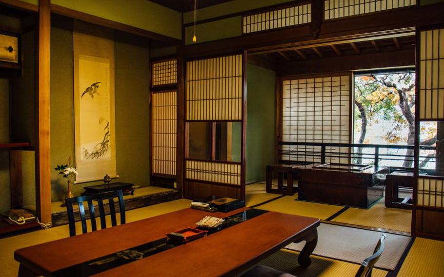 two chairs and a table in a room of the ryokan.