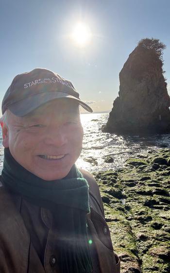 Takahiro poses for a photo on the beach.