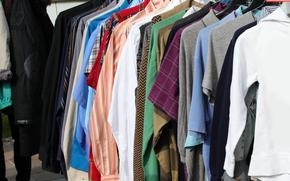 vintage used clothes and new dresses in the stall at the flea market