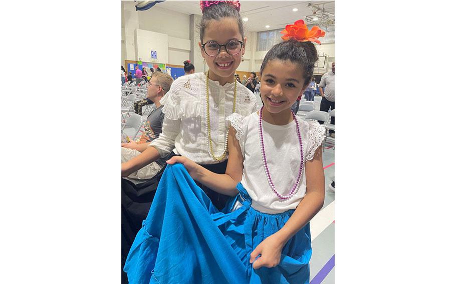 Two girls with thier dresses on pose.