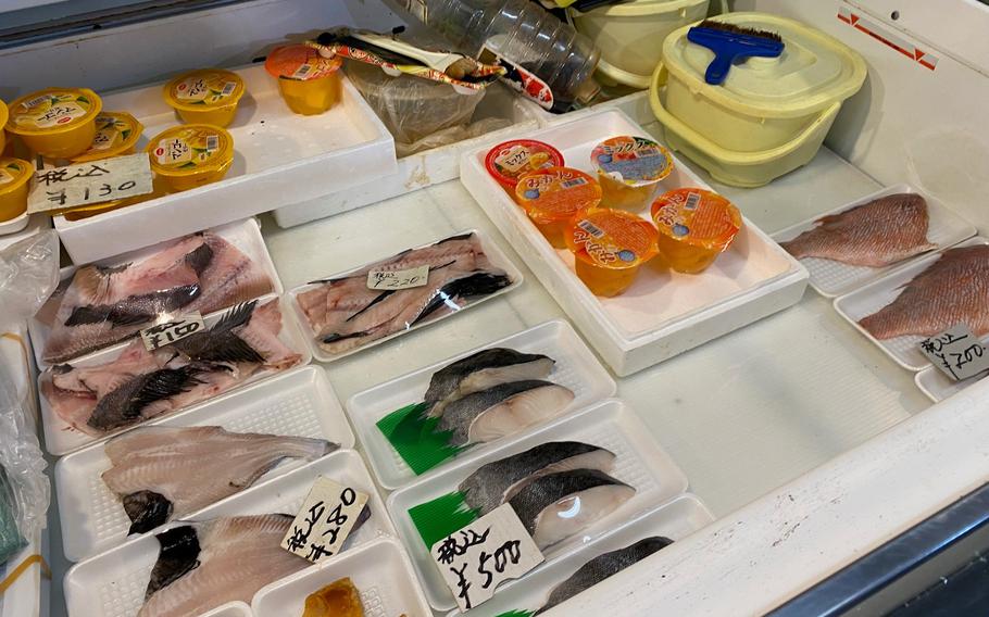 Cut fish are displayed in a container.