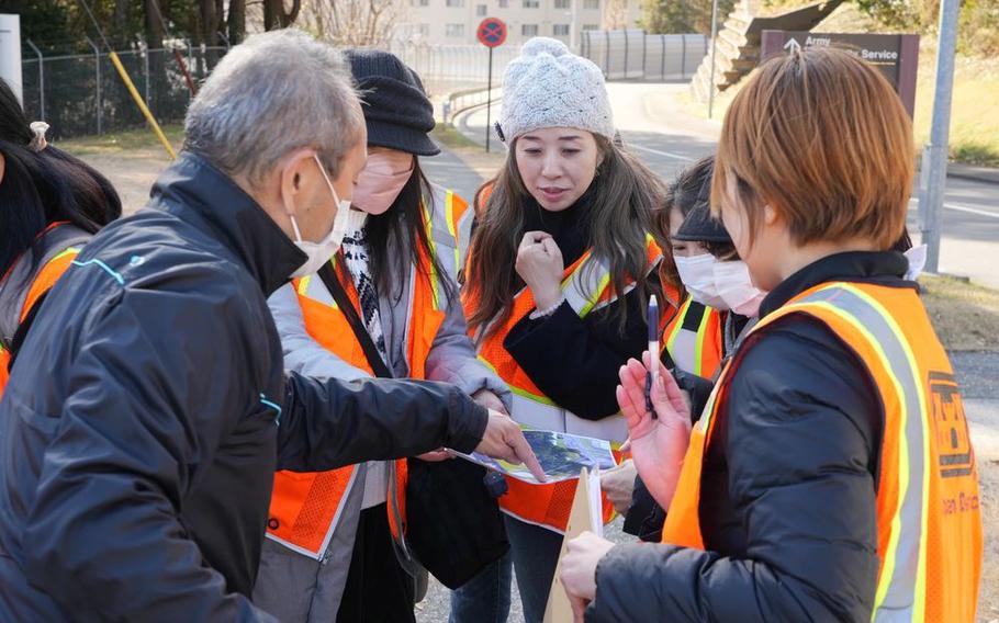 Japanese civilians taking part in the U.S. Army Corps of Engineers Winter Outreach Event learn about a construction project underway on Camp Zama, Japan.