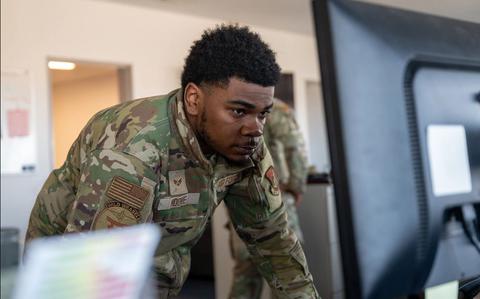 Photo Of Senior Airman James Moore monitors the daily flight schedules.