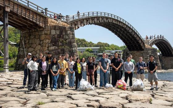 Volunteers from Marine Corps Air Station Iwakuni pose for a group photo after picking up trash during a clean-up at the Kintaikyo Bridge, Iwakuni, Japan, April 21, 2025. The Marine Corps Community Services Iwakuni, Single Marine Program hosted a bridge clean-up as part of the SMP Days of Service, a five-day series of events where service members from Marine Corps Air Station Iwakuni volunteer to build stronger relationships and give back to the community. 